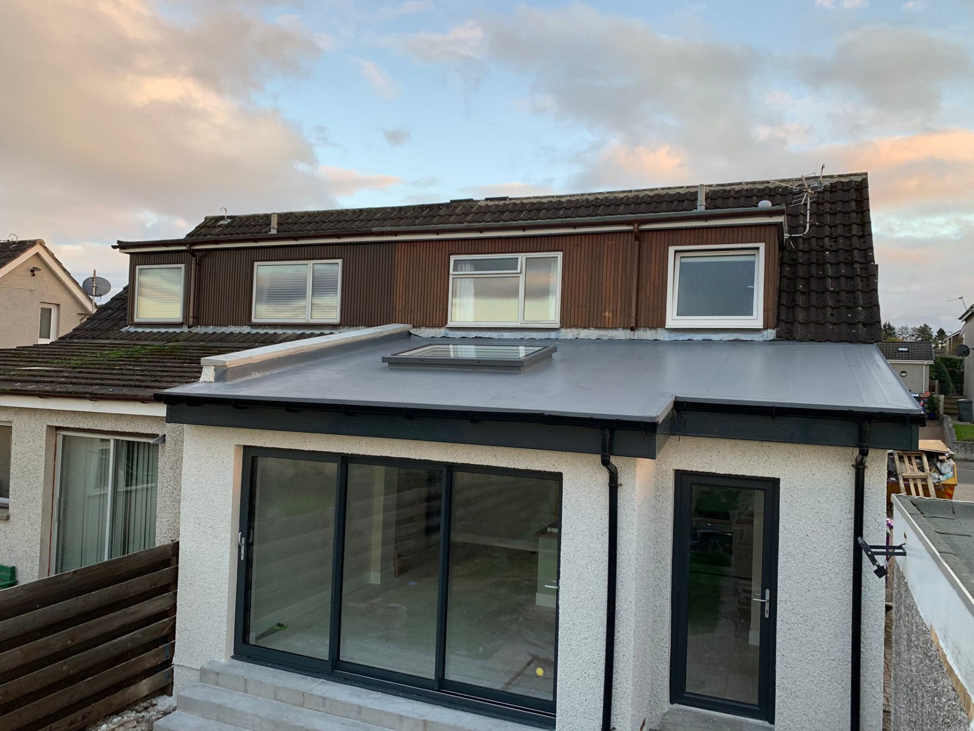Two-storey extension with bi-fold doors and flat roof